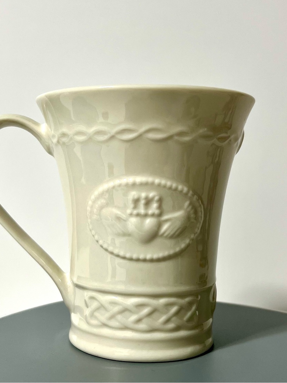 Belleek Cream Ceramic Mug with Embossed Claddagh and Celtic Band